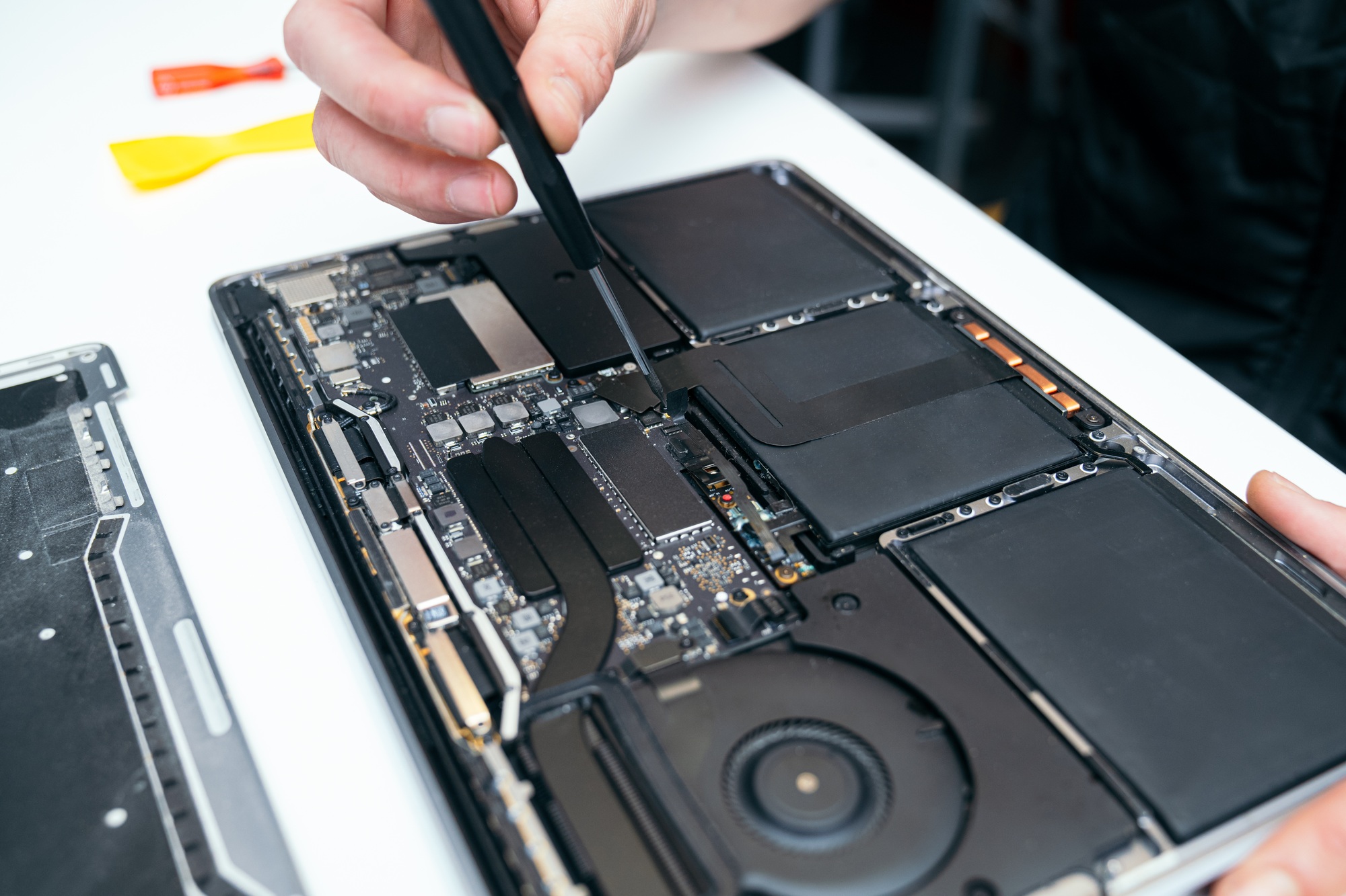 Unrecognizable Person Repairing Open Laptop's Internal Components